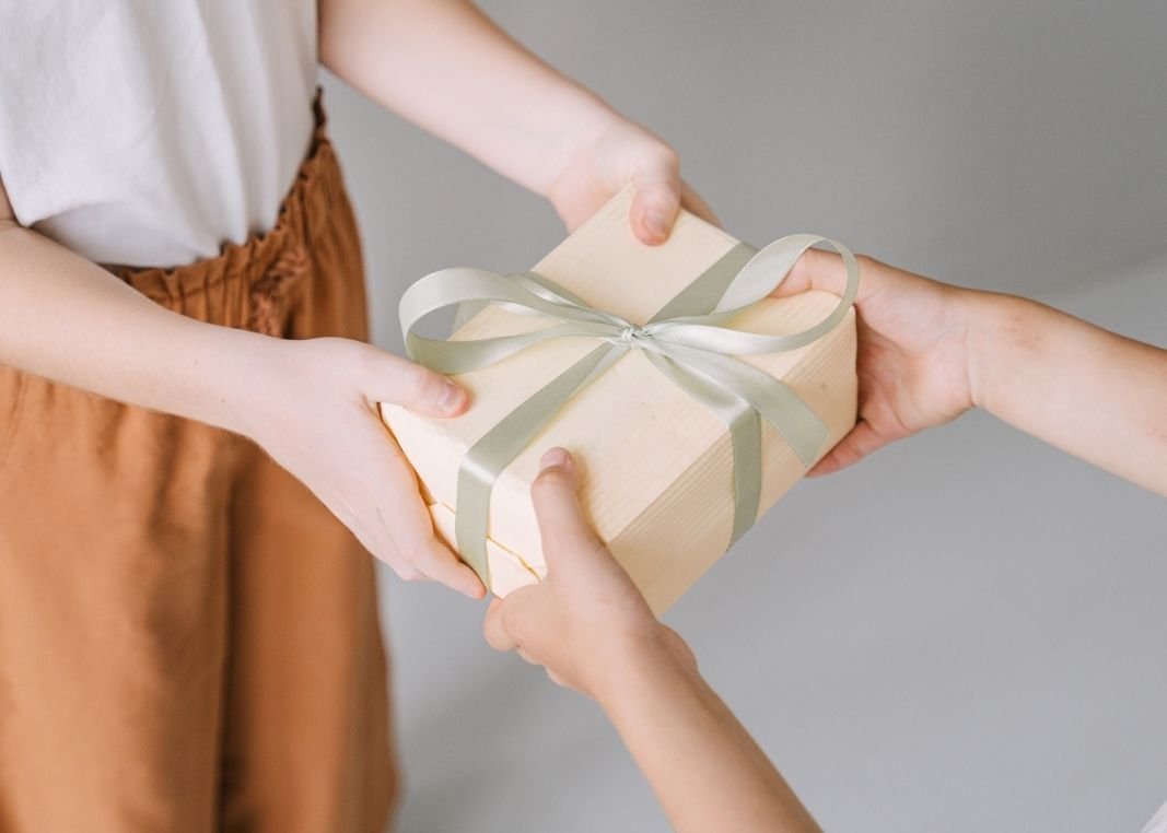 A person gifting a planner to someone for new year