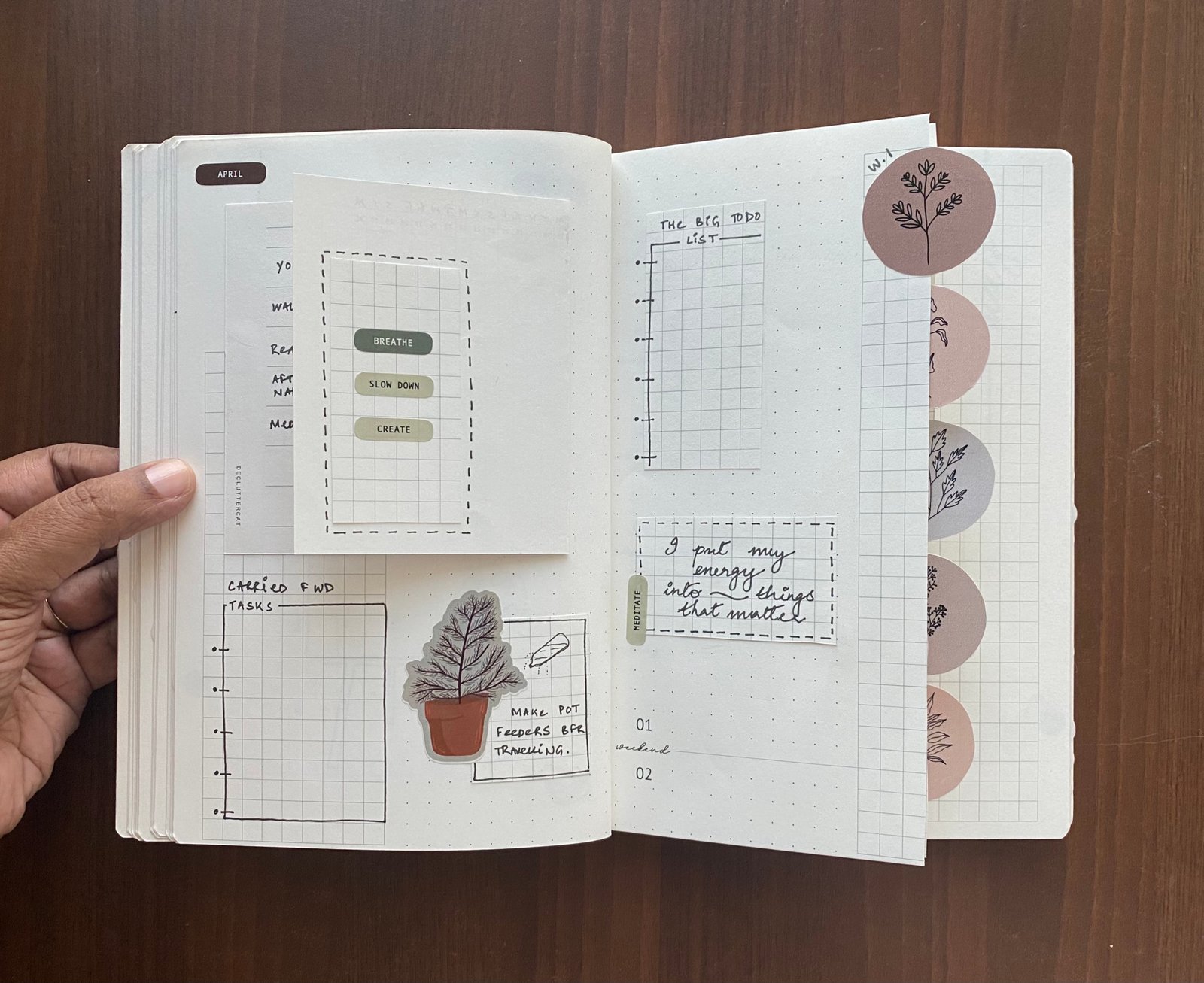 Someone planning anew year with Rhythm, the Decluttercat Planner 